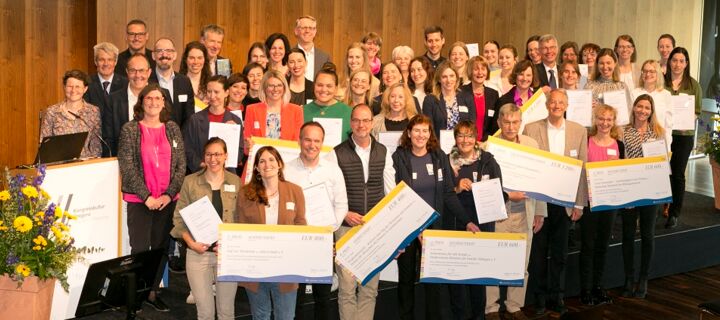 Gruppenfoto der Teilnehmerinnen und Teilnehmer auf Bühne